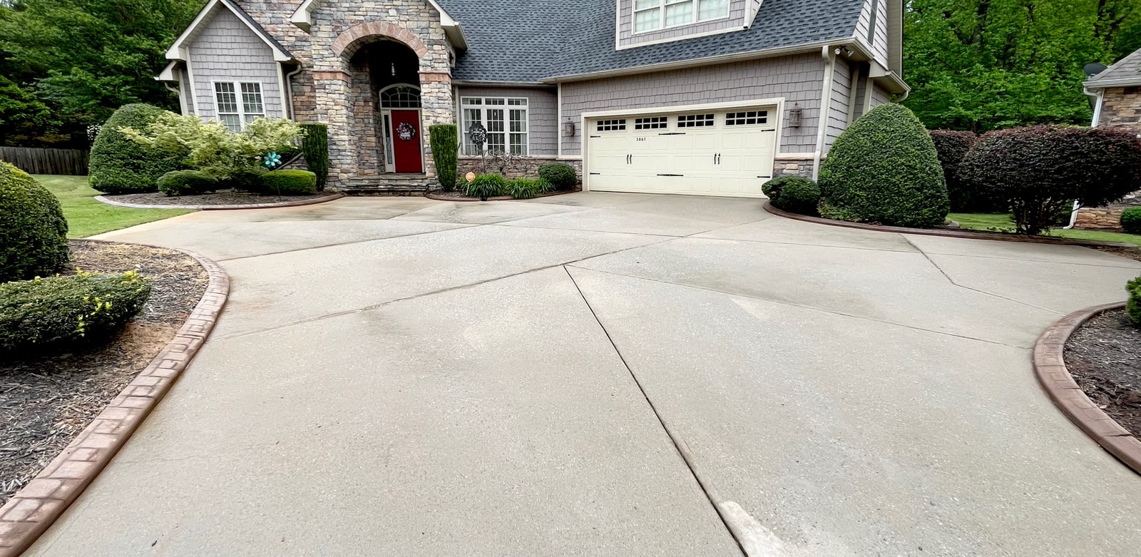 Clean residential driveway after a completed CK Pressure Washing concrete cleaning project