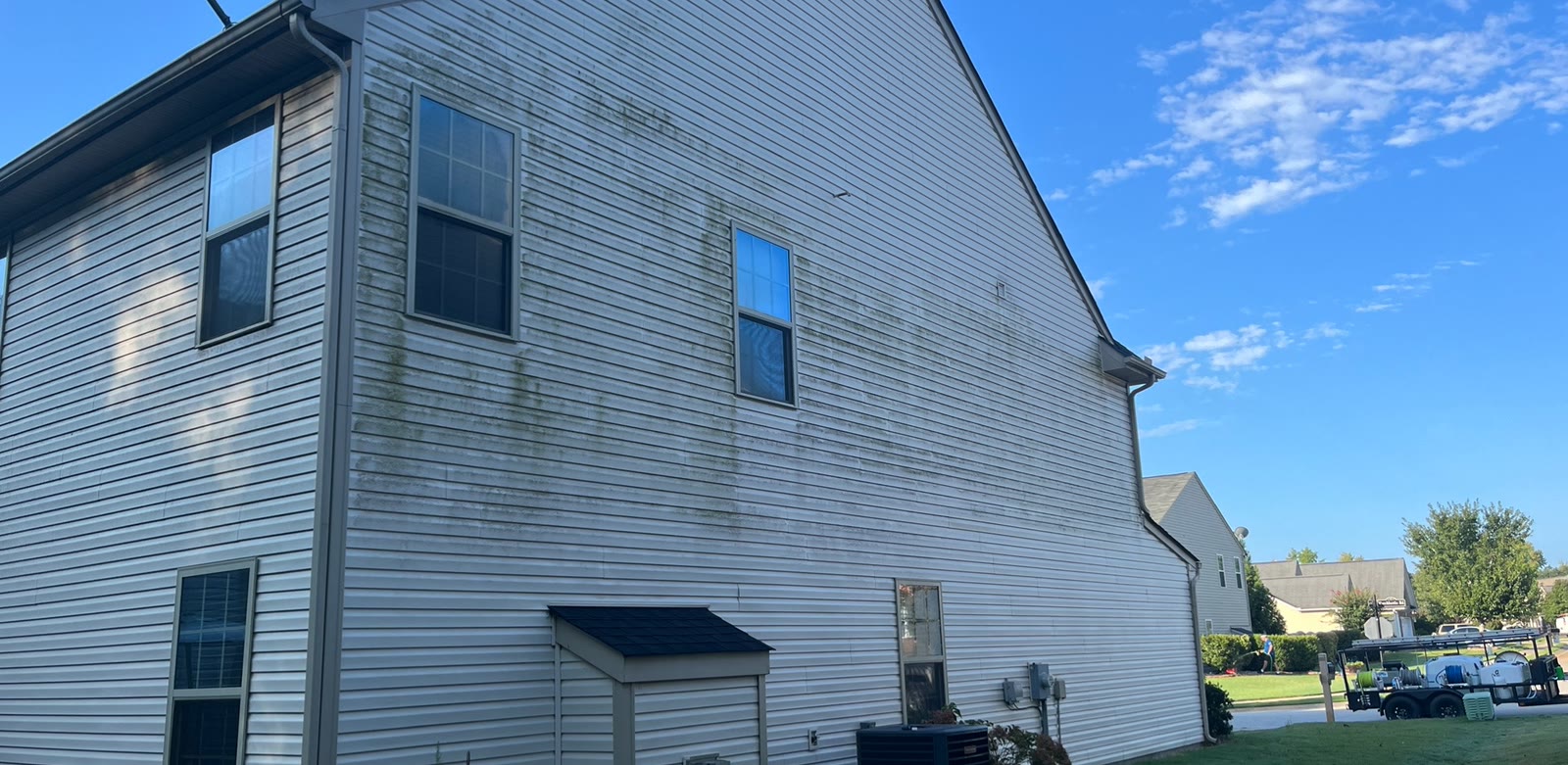 House siding before a CK Pressure Washing house wash